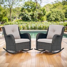 two wicker rocking chairs in front of a pool