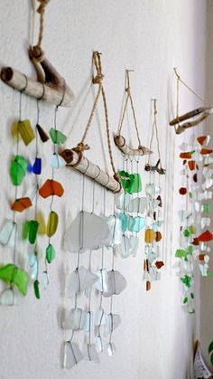 there are many colorful glass pieces hanging on the wall