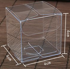 a clear plastic box sitting on top of a wooden floor