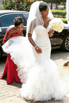 two women in wedding dresses walking down the street