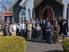 a group of people standing in front of a church