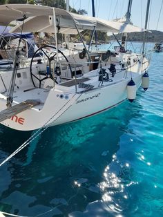 the sailboat is docked in the clear blue water