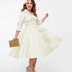 This Stunning 1950s Dress From Unique Vintage Is Crafted In A Dazzling Ivory Brocade Fabric And Is Accented With Gold Eyelets And A Collar. Complete With Button Front, Side Pockets And Full Swing Skirt! Shell: 65% Polyester, 35% Cotton; Lining: 95% Polyester, 5% Spandex Hand Wash Cold, Hang Dry Lined, Button Front Side Pockets Material Has No Stretch Cream Tea Length Dress For Formal Occasions, Classic Cream Dress For Vintage Events, Retro Beige Dresses For Vintage Events, Fitted Beige Dress For Vintage Events, Beige Fitted Dress For Vintage Events, Cream Tea Length Dress For Garden Party, Vintage Cream Tea Length Dresses, Vintage Cream Tea-length Dresses, Classic Dresses For Spring Vintage Events