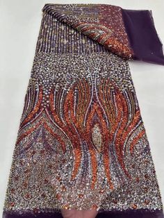 an orange and purple scarf with silver sequins