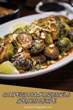 a white plate topped with brussel sprouts covered in sauce