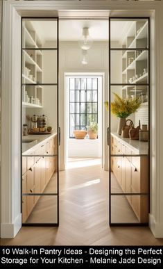 an open door leading into a kitchen with lots of shelves and drawers on the wall