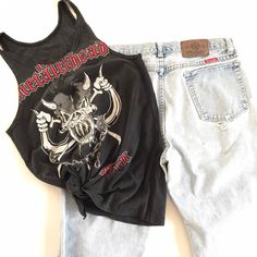 This was a men's Metallica Fan Club tee that was reworked into a small women's tank. It's one of a kind. There is a rip in the lower front that was used to tie the bottom of the shirt with. I've provided measurements in the photos for an accurate fit. It's the perfect true vintage Metallica fan tee to partner with your trashed hi rise 90's jeans and your docs. And it's already reworked and custom cut ⚡️ (14) Grunge Tank T-shirt For Summer, Summer Grunge Tank T-shirt, Graphic Print Racerback Top For Streetwear, Graphic Print Tank Tops For Festivals, Festival Graphic Print Tank Tops, Casual Graphic Print Tank Top, Distressed Band Merch Top For Fans, Cotton Tank Top With Graphic Print For Festivals, Cotton Graphic Print Tank Top For Festivals