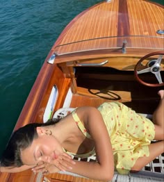 a woman laying on the deck of a boat