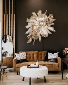 a living room filled with furniture and a large feather decoration on the wall above it