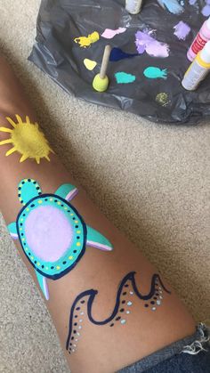 someone has their arm painted with different designs