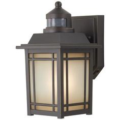 an outdoor wall light with a lantern on it