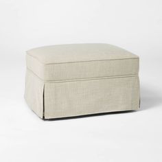 a white ottoman sitting on top of a white floor