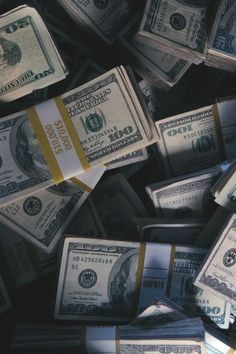 black and white photograph of stacks of one hundred dollar bills with the image taken from above