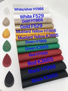 different colors and sizes of fabric on a white table with black, red, green, blue, yellow, orange