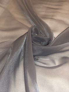 "Shiny organza fabric:- grey in colour  width is 45\" inches(112cm) shiny light weight smooth fabric  can be used for multiple projects dresses,crafts,face masks,scrubs,upholstery,bedding,children clothes,table tops ,curtains,cushions etc this price is for one meter and if you will buy more than one meter it will come as one continuous length  please note that we try our best to get the actual colour of the fabric but because of the camera effects and different monitoring screens colours may sli Shiny Organza Dress, Wide Dress, Camera Effects, Upholstery Bed, Organza Gowns, Bridal Decorations, Shiny Fabric, Organza Dress, Metallic Fabric