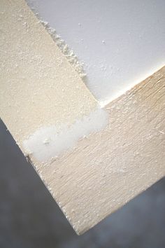 the corner of a wall with white paint on it