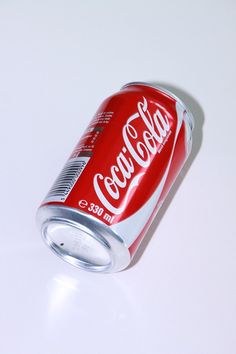 a can of soda sitting on top of a table