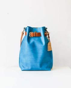 Women's Leather Bag, Leather Backpack, Leather Rucksack, Convertible Backpack, Cross Body Bag The leather backpack, you just can't keep your eyes off! The most beautiful color combination imaginable. This blue beauty is Handmade from finest leather, very practical to use on everyday bases. You can even choose how to use it- As a Convertible bag- Cross body Bag, Backpack, Handbag, or as just an awesome Cross body bag no one can resist. The belt of beg is super adjustable and it gives you the oppo Modern Bucket Backpack For Travel, Large Capacity Blue Leather Backpack, Blue Backpack With Dust Bag For Everyday Use, On-the-go Leather Bucket Backpack, Leather Satchel Backpack For Daily Use With Dust Bag, Modern Bucket Backpack For Daily Use, Leather Handle Bucket Backpack For Travel, Rectangular Leather Backpack With Dust Bag For Travel, Rectangular Leather Backpack For Travel With Dust Bag