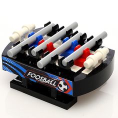 a toy foosball set with four different colored balls