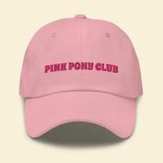 A classic hat with "Pink Pony Club" embroidered on the front. The hat has a low profile with an adjustable strap and curved visor. * 100% chino cotton twill * Unstructured, 6-panel, low-profile * 6 embroidered eyelets * 3 ⅛" (7.6 cm) crown * Adjustable strap with antique buckle This product is embroidered for you as soon as you place an order, which is why it takes us a bit longer to deliver it to you. Making products on demand instead of in bulk helps reduce waste and overproduction, so thank you for helping Sapphic Life Guide contribute to sustainable fashion. Trendy Adjustable Cap, Trendy Adjustable Fit Cap, Adjustable Trucker Hat With Embroidered Logo And Visor, Adjustable Hat With Letter Print And Curved Visor, Adjustable Curved Visor Hat With Letter Print, Adjustable Hats With Embroidered Logo And Curved Visor, Trendy Pink Dad Hat With Curved Visor, Trendy Trucker Hat With Embroidered Logo And Visor, Pink Hats With Letter Print And Curved Bill