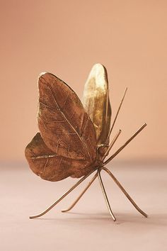 a golden butterfly sitting on top of a table