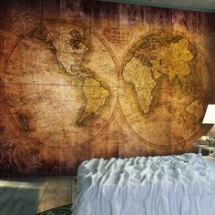 a bedroom with a large map on the wall and a bed in front of it