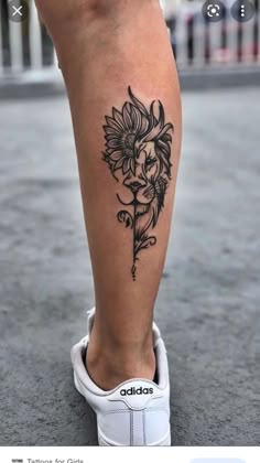 a woman's leg with a flower tattoo on the lower part of her leg