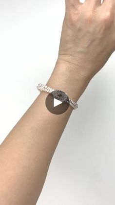 a woman's arm with a bracelet on it and a ring around the wrist