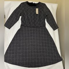 Nwt; Banana Republic Dress Petite Gray Plaid Lined Zip Fit & Flare Sz;6p N. The Dress Features A Gray Plaid Pattern With Colorful Flower Accents, Perfect For A Fall Party Or Casual Outing. The Fit And Flare Style Is Flattering On Any Body Type And The Knee-Length Cut Adds A Touch Of Sophistication. The Dress Is Made Of A Comfortable Knit Fabric, Consisting Of Polyester, Spandex, Rayon, And Viscose. It Has 3/4 Sleeves, A Round Neckline, And A Zip Closure For Easy Wear. The Dress Is Machine Washab Gray A-line Winter Dresses, Gray Long Sleeve Dress For Work, Gray Winter Dresses For Work, Gray Winter Work Dresses, Gray Winter Workwear Dresses, Gray Midi Length Dress For Work, Gray Knee-length Workwear Dress, Gray Knee-length Dress For Work, Fitted Gray Dress For Fall