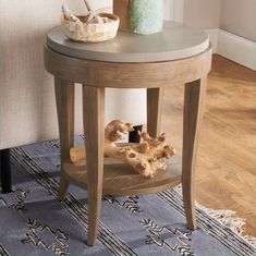 a wooden table with a vase on top of it next to a small dog bone