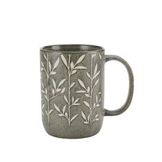 a gray mug with white leaves on the outside and inside, sitting in front of a white background