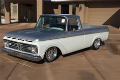 an old pickup truck parked in front of a house