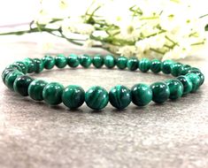 ✦Gemstone: Natural Malachite ✦Color: Green ✦Shape: Round  ✦Length: Choose your size ✦Bead Size: 6mm ✦Weight: 69ct ✦QTY: 1 pcs / package ♕Beautiful & High Quality Findings♕ You will receive the same quality as you see in picture. CLICK BELOW TO CHECK ALL OUR BEAUTIFUL GEMSTONE BRIOLETTES. https://www.etsy.com/shop/TurquoiseFactory?ref=seller-platform-mcnav Color may vary slightly due to your monitors' color calibration settings. Please allow 0.2-0.5mm measurement error due to different measurement manner. PLEASE feel free to contact us, if you have WHOLESALE QUERY OR ANY OTHER QUESTION Thanks for your kindly understand! Green Gemstone Bracelet, Healing Gemstone Bracelets, Malachite Bracelet, Reiki Jewelry, Amazonite Bracelet, Malachite Jewelry, Green Malachite, Stretchy Bracelets, Christmas Gift Jewelry