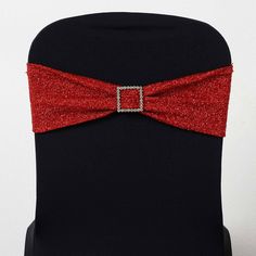 a black chair with a red bow tie on it's lapel and the seat is covered in sequins