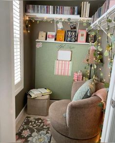 a living room filled with furniture and bookshelves next to a window covered in christmas lights