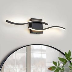 modern wall light with curved design in black and white finish, dimmer on the ceiling