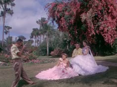 the princess and the frog are sitting on the grass in their wedding gowns,