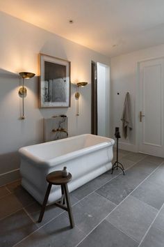 a large white bath tub sitting in a bathroom