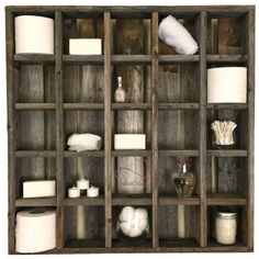 a wooden shelf filled with lots of different types of toilet paper