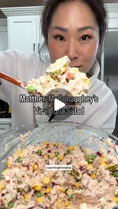 a woman holding a spoon full of food