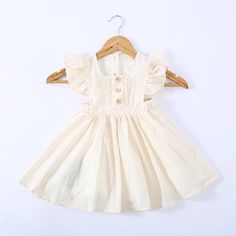 Girls Pure Cotton Pleated Skirt Solid Color Fly Sleeve Princess Dress - PrettyKid Cute Solid Color Dress For Dress-up, Cute Summer Dresses In Solid Color, Cute Solid Color Summer Dresses, Beige Solid Color Cotton Dress, Cute Solid Color Spring Dresses, Fitted Cream Solid Color Dress, Solid Color Dresses With Ruffles In Cute Style, Solid Color Short Sleeve Dress For Dress-up, Cute Beige Cotton Dress