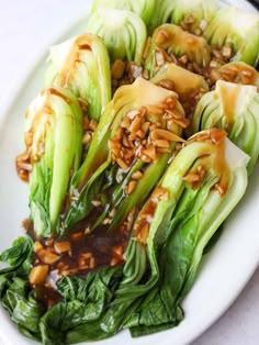 lettuce with sauce and nuts on a white plate