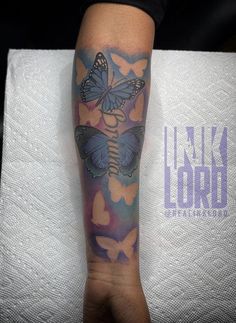 a person with a butterfly tattoo on their arm