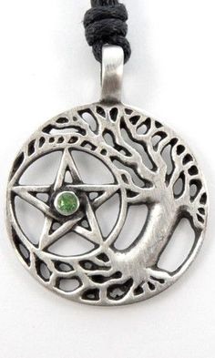 a pentagramil with a green stone in the center on a black cord necklace