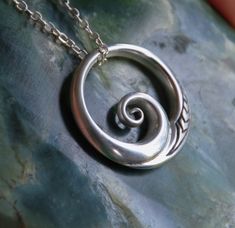 Hand crafted New Zealand Maori Koru design in Solid 925 sterling silver. The Maori koru is a treasured symbol in New Zealand, it brings renewal & spiritual growth, with inspiration for new ideas & projects and can symbolise a new start in life. As a wave design it brings energy & vitality and connections with the ocean. With a delicate engraving of the New Zealand fern. These are uniquely New Zealand designs by my partner & I here in NZ. They are fully 3D sculptural pieces & New Zealand Fern, Maori Koru, Wave Pendant, A New Start, My Partner, New Start, Wave Design, Ethnic Jewelry, Spiritual Growth