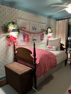 a bedroom decorated for christmas with red and white decor