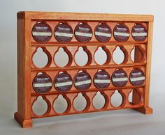 a wooden rack with twelve coasters on it's sides and holes in the middle