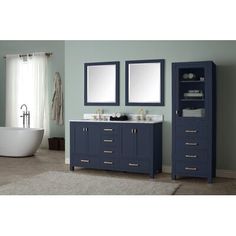 a bathroom with blue cabinets and a white bathtub in the corner next to it