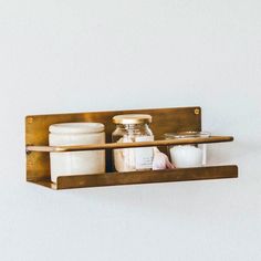 two shelves with jars and containers on them