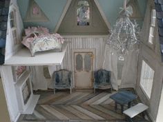 a doll house with furniture and chandelier in it